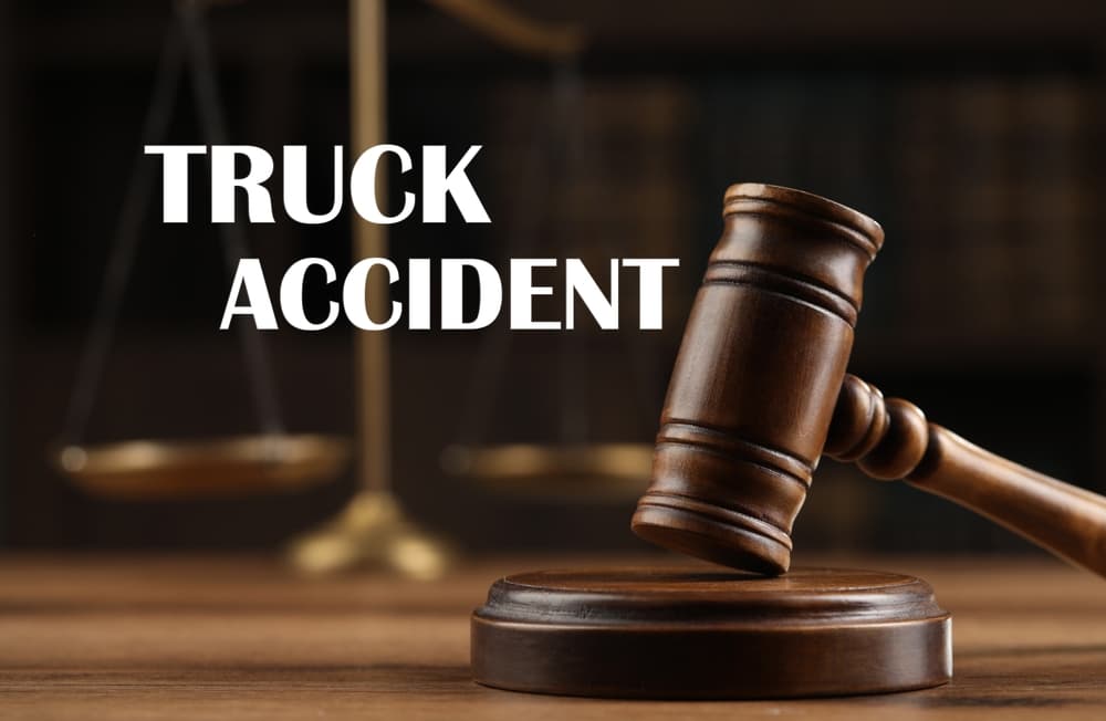 Truck accident law. Wooden judge's gavel and scales of justice on table